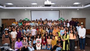 Dr. Vineeta Goel addressing Delhi University students and faculty during a breast and cervical cancer awareness workshop, featuring a TFD (Touch, Feel & Detect) session on breast self-examination.